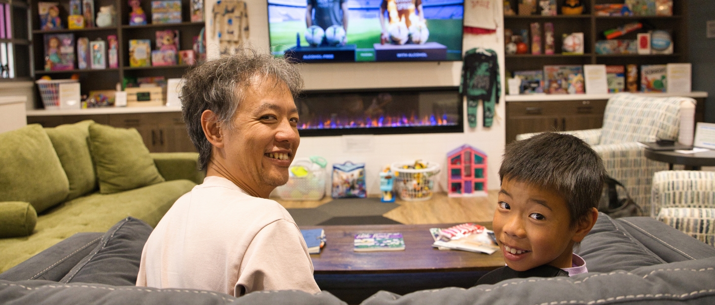 Father and son watching T.V. in the Family Room.