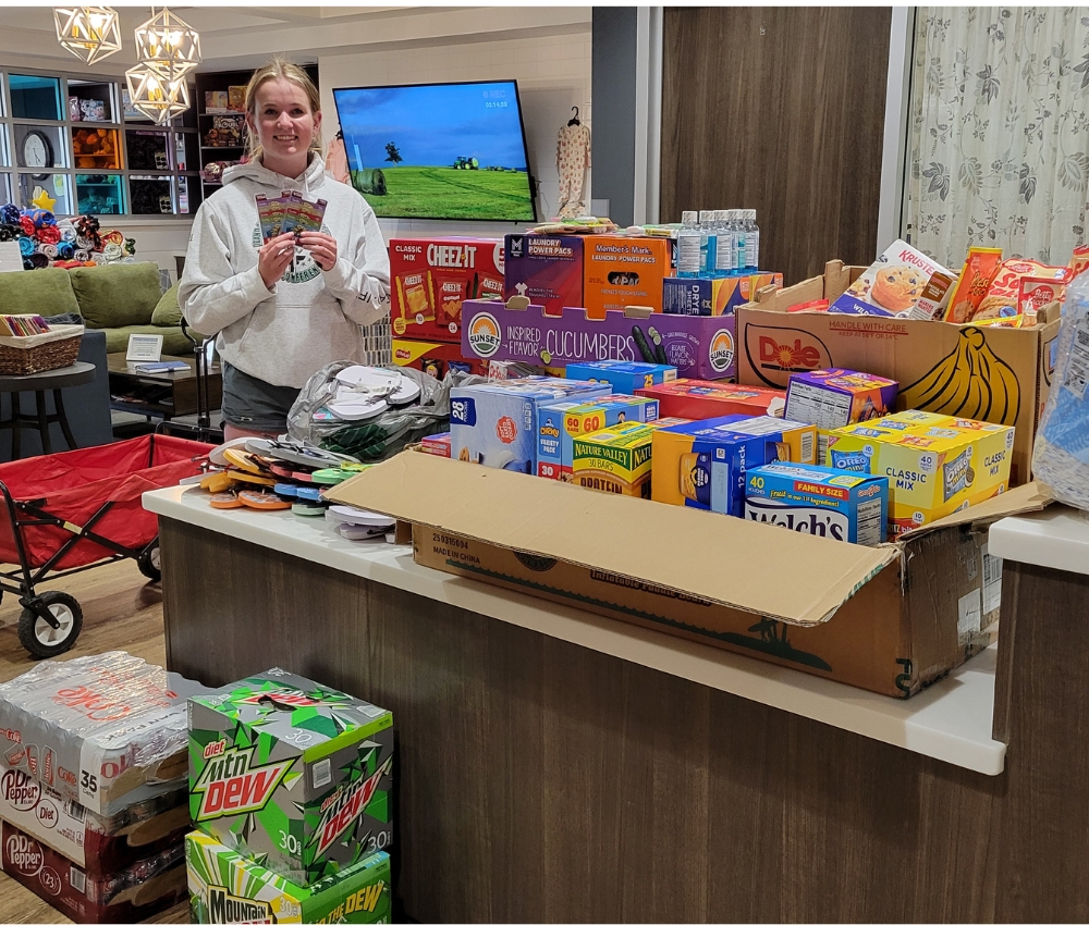 High school student with her donation at the Family Room.