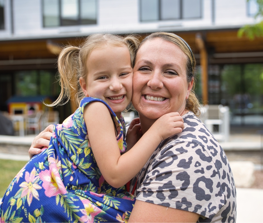 Mom and daughter hugging.