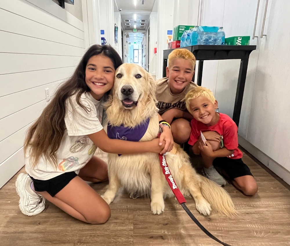 Kids with our therapy dog, Teddy.